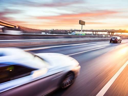 Several cars running on the highway in the picture, which is used to stand for automotive industry.