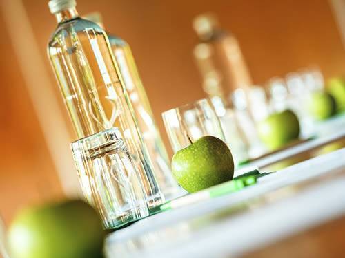 Fruits and bottles of water are shown in the picture, standing for food and beverage industry.